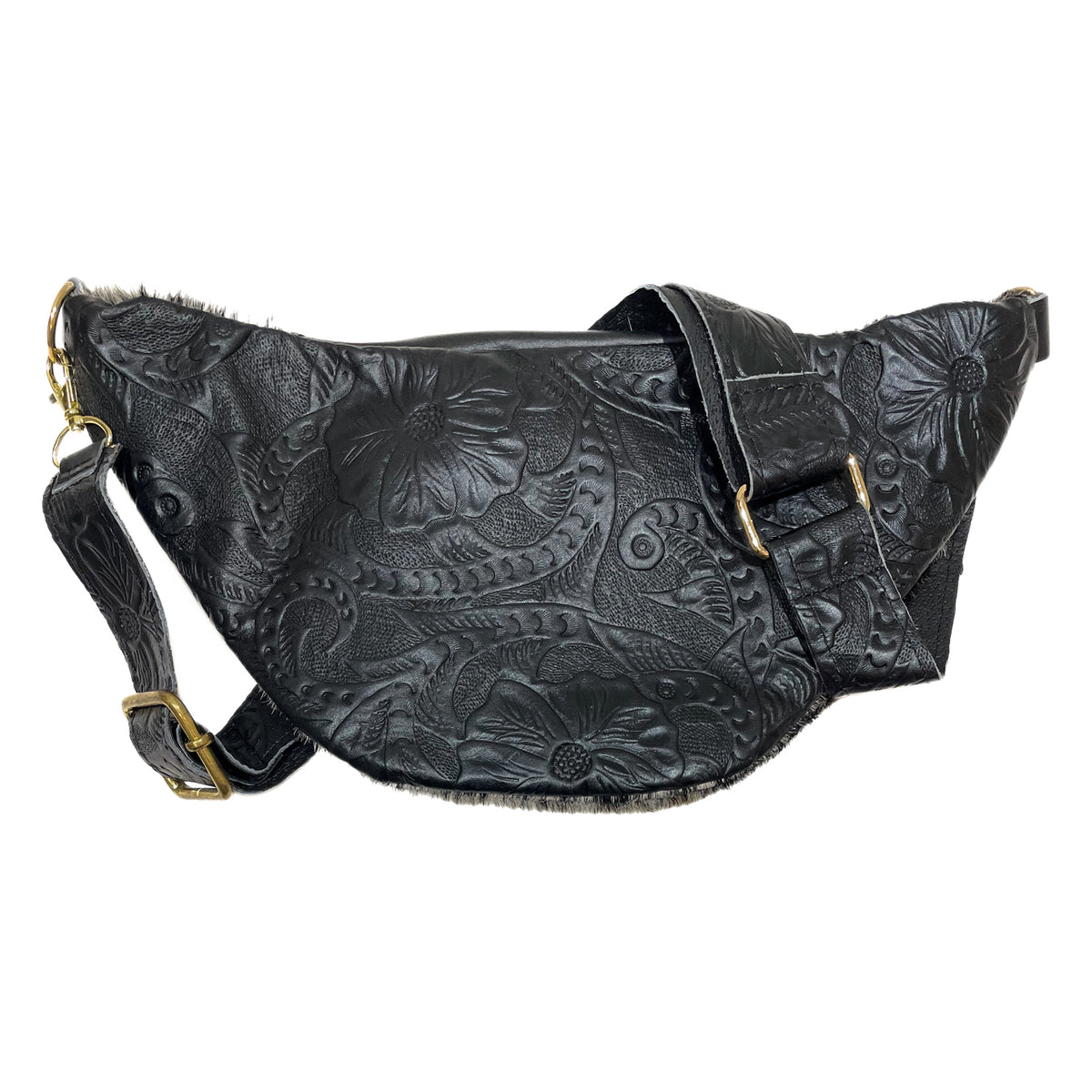 Back of black cow hair leather fanny pack showing adjustable tooled leather strap and gold-tone hardware. 