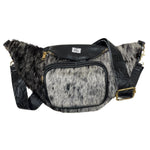 Black cow hair leather fanny pack with genuine cowhide exterior, leather trim, zippered compartments, and adjustable strap. 