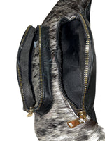 Black cowhide leather waist bag with zippered main compartment and spacious interior for everyday essentials. 