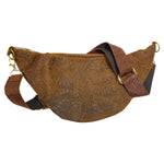Back of light brown cow hair leather fanny pack showing adjustable tooled leather strap and gold-tone hardware. 