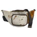 Brown cow hair leather fanny pack with genuine cowhide exterior, leather trim, zippered compartments, and adjustable strap. 