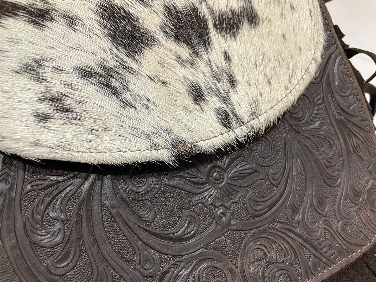 closeup of leather engraving details and real cow hair bag 