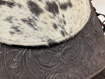 closeup of leather engraving details and real cow hair bag 