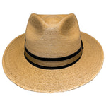 Tan-Beige Fedora Fino worn as a lightweight Mexican palm leaf fedora for travel, outdoor adventures, and sunny summer days. 