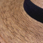 Video showcasing the Indiana Classic Hat with a closeup of the artisanal woven straw fibers and the classic black hat band
