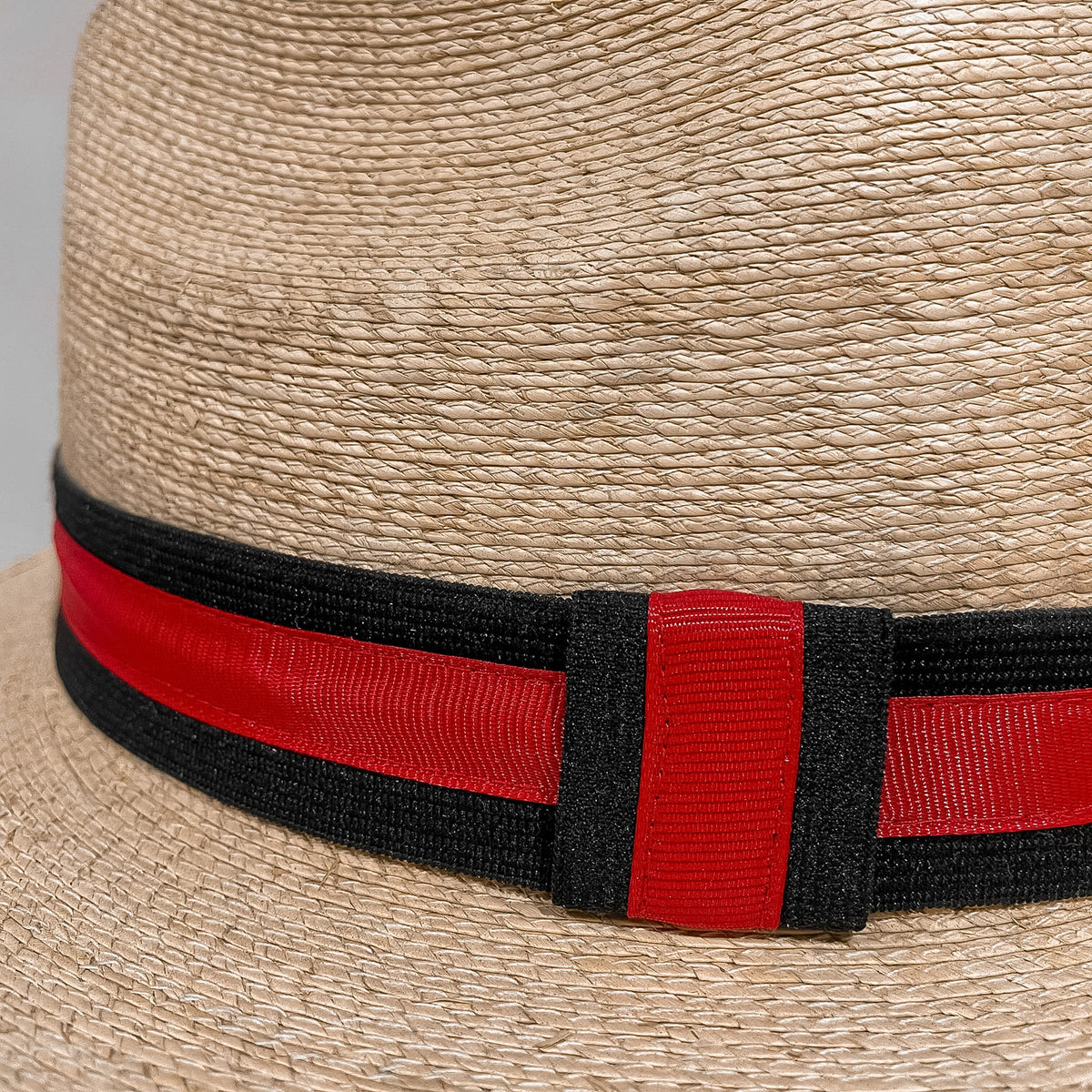 Close-up of Natural-Red Fedora Fino showing handwoven Mexican palm leaf texture and detailed artisan craftsmanship. 